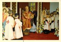 Photograph of service at the Holy Ghost Ukrainian Catholic Parish, Bishop doing blessing for the Holy communion.