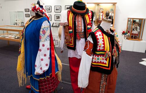 The pair in the vests with bright colours and geometric shapes are costumes representative of the mountainous Hutsul region of Ukraine. These costumes, and many others, have been used in performances and parade floats by Sydney’s Ukrainian dancers. / Costumes: Kenny Horechuk / CKP_4005
