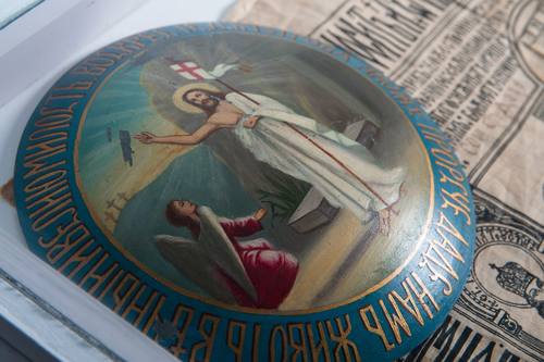 The round, domed icon of the Resurrection that also sits in this case is a cover for the Arktos, or Bread of Resurrection. This bread and icon are part of prayerful celebrations on Easter weekend.