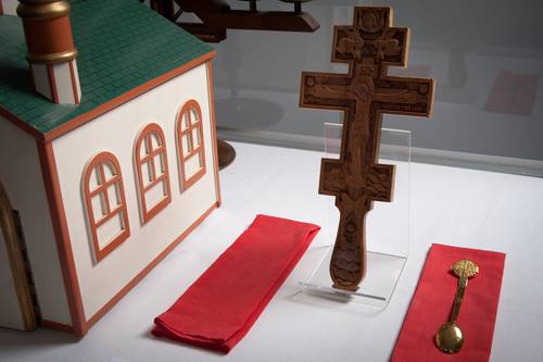 To the right of the Tabernacle sits a wooden hand-cross. This one is carved out of linden wood, and on two sides. It was carved for Father Roman Dusanowskyj, the parish’s current priest. This cross was carved in Lviv, Ukraine by a seminarian as gift for Fr. Roman. The carvings depict the crucified Christ on one side, and the Mother of Sorrows on the other. Two red cloths, purificators also sit on the altar. A communion spoon from the parish’s earliest years. The spoon is decorated with an anchor-cross – so it is likely that it was made specifically for the Holy Ghost Ukrainian Parish in Sydney, NS.
