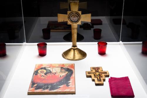 This tetropod, or Table of Needs, holds a cross with a Holy Relic of St. Josephat, candles, icons and a cloth. Other items are placed on the tetropod as needed.