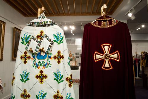 The vestments hanging here are used by the priests of the Holy Ghost Ukrainian Catholic parish. The embroidered vestments are originally from Ukraine. The red vestment is used during solemn occasions such as funerals and Great Lent.